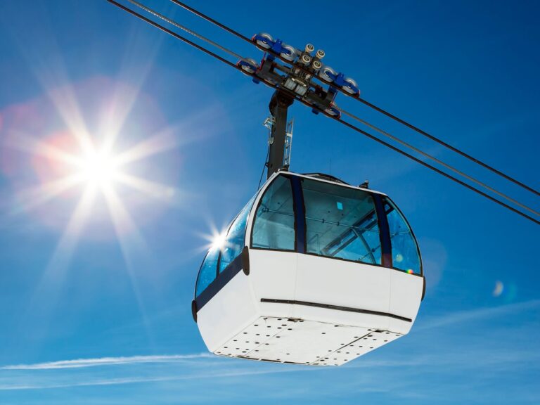 Cable car and sun in a mountain area